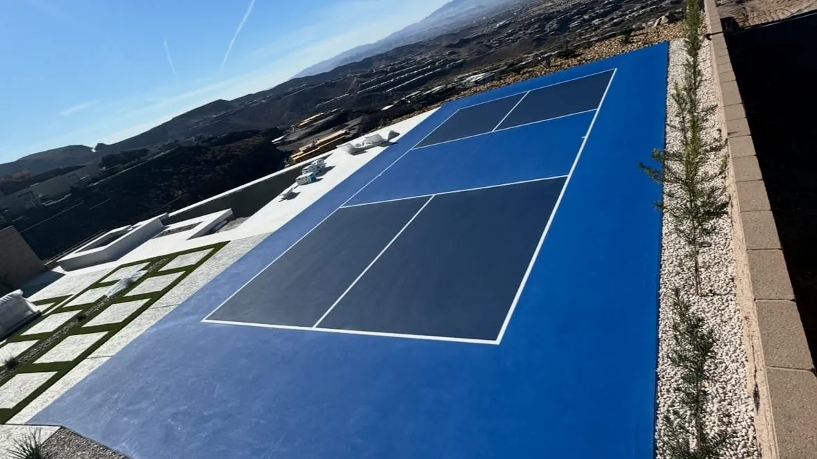 Finished all-blue backyard pickleball court built by On Point Court Surfacing on a Las Vegas hillside lot with desert mountain views