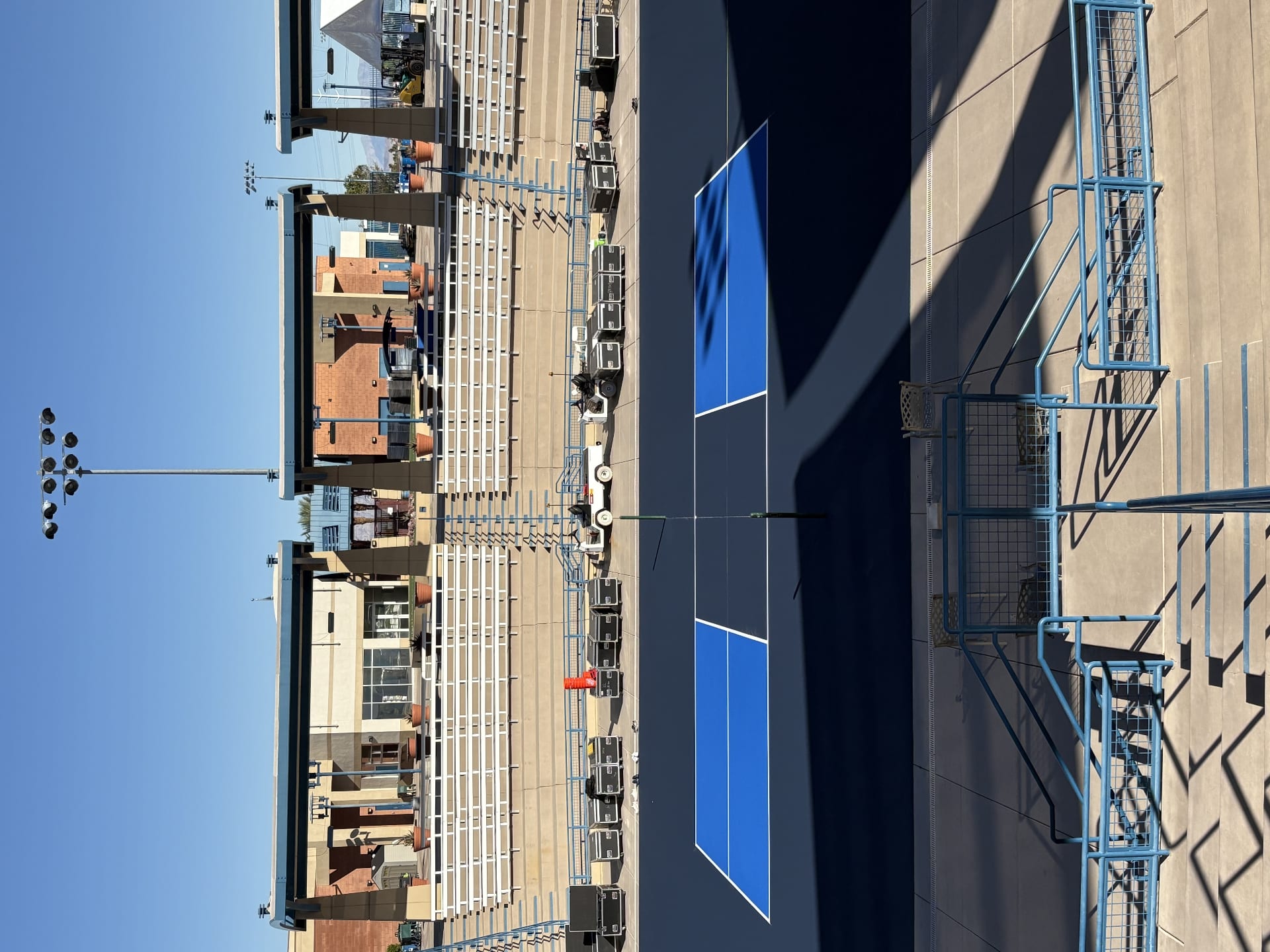 Professional pickleball stadium court in Las Vegas featuring blue surfacing and tiered spectator seating.