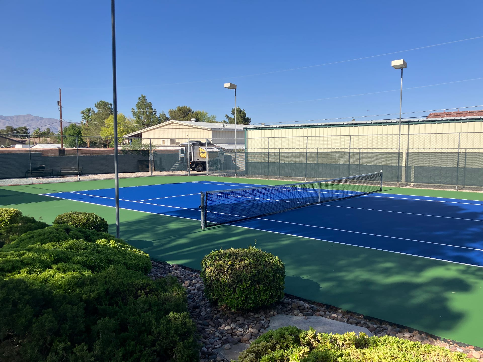 A freshly resurfaced blue and green tennis court at a private residence in Southern Nevada.