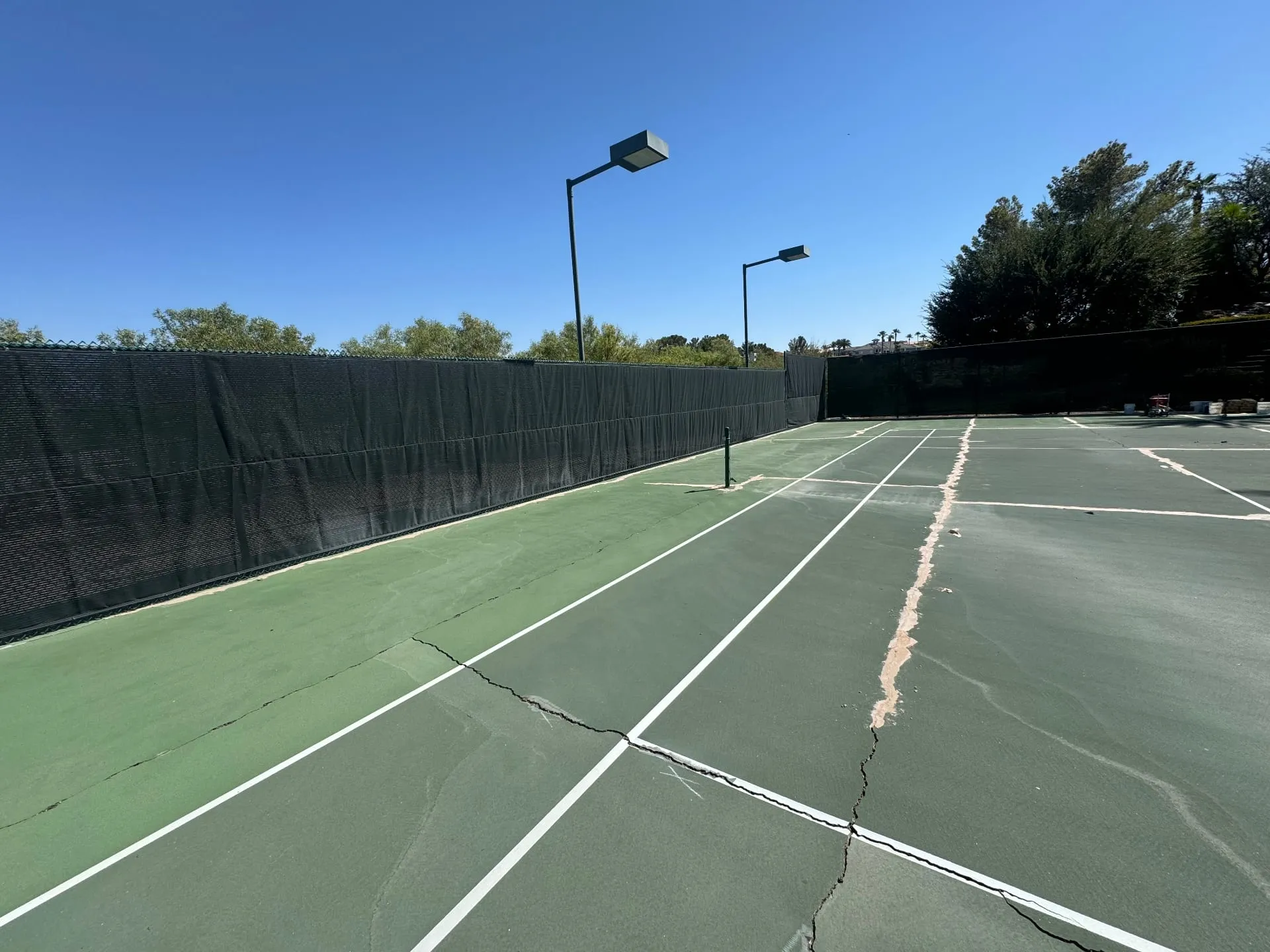 Worn pickleball and tennis court surface in Las Vegas, NV showing cracks before resurfacing