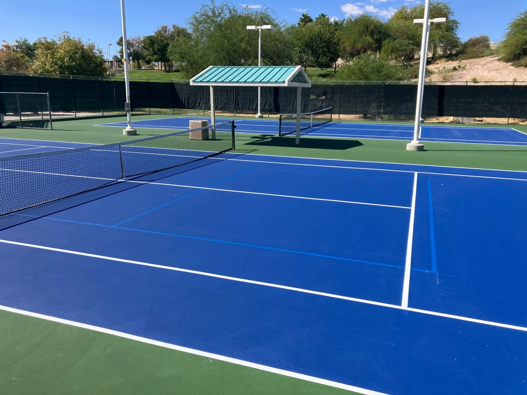 Tennis court in Las Vegas, NV striped with added pickleball lines for shared use