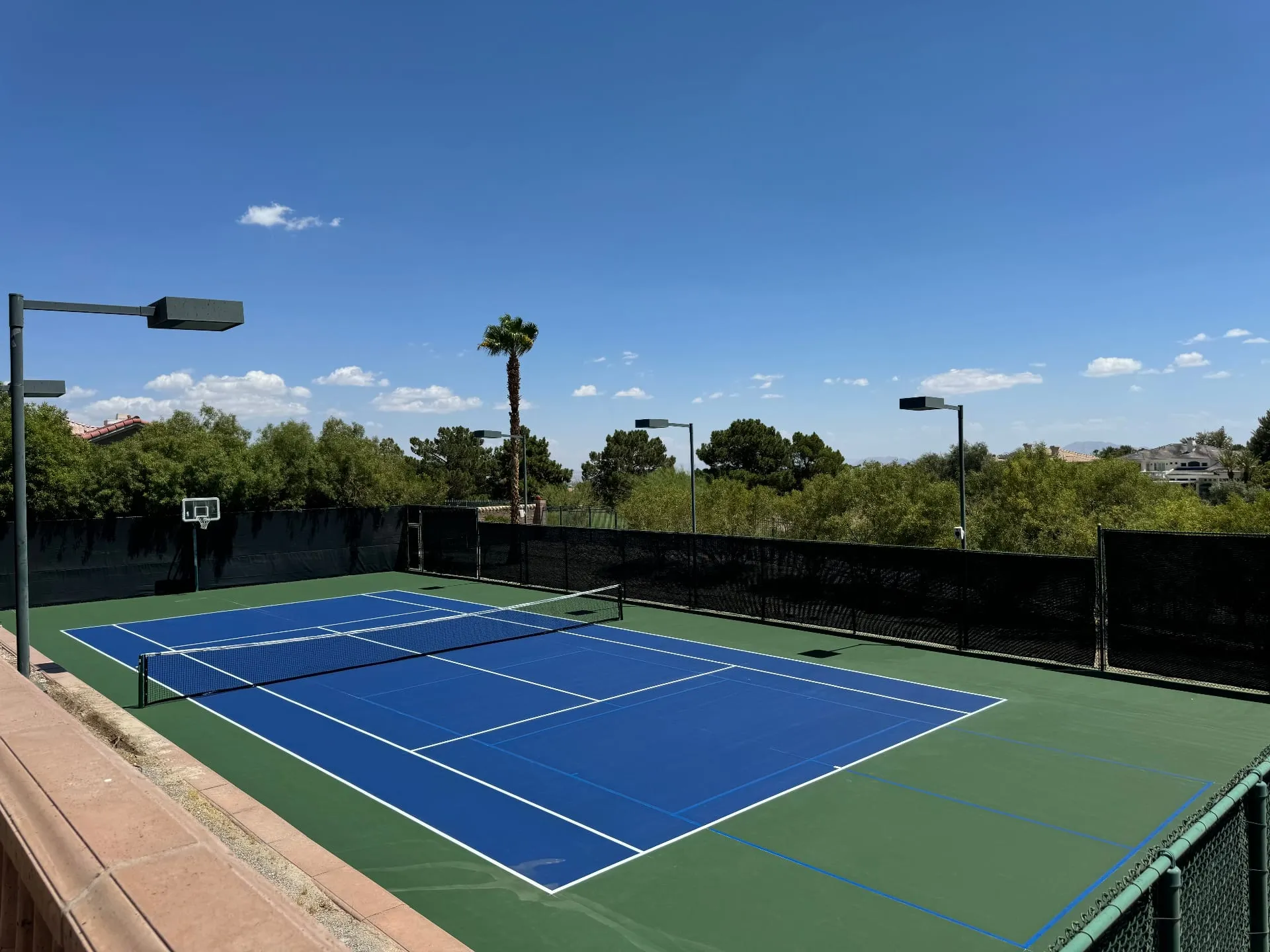 The same court freshly resurfaced with a blue and green acrylic finish after professional repair in Henderson, NV